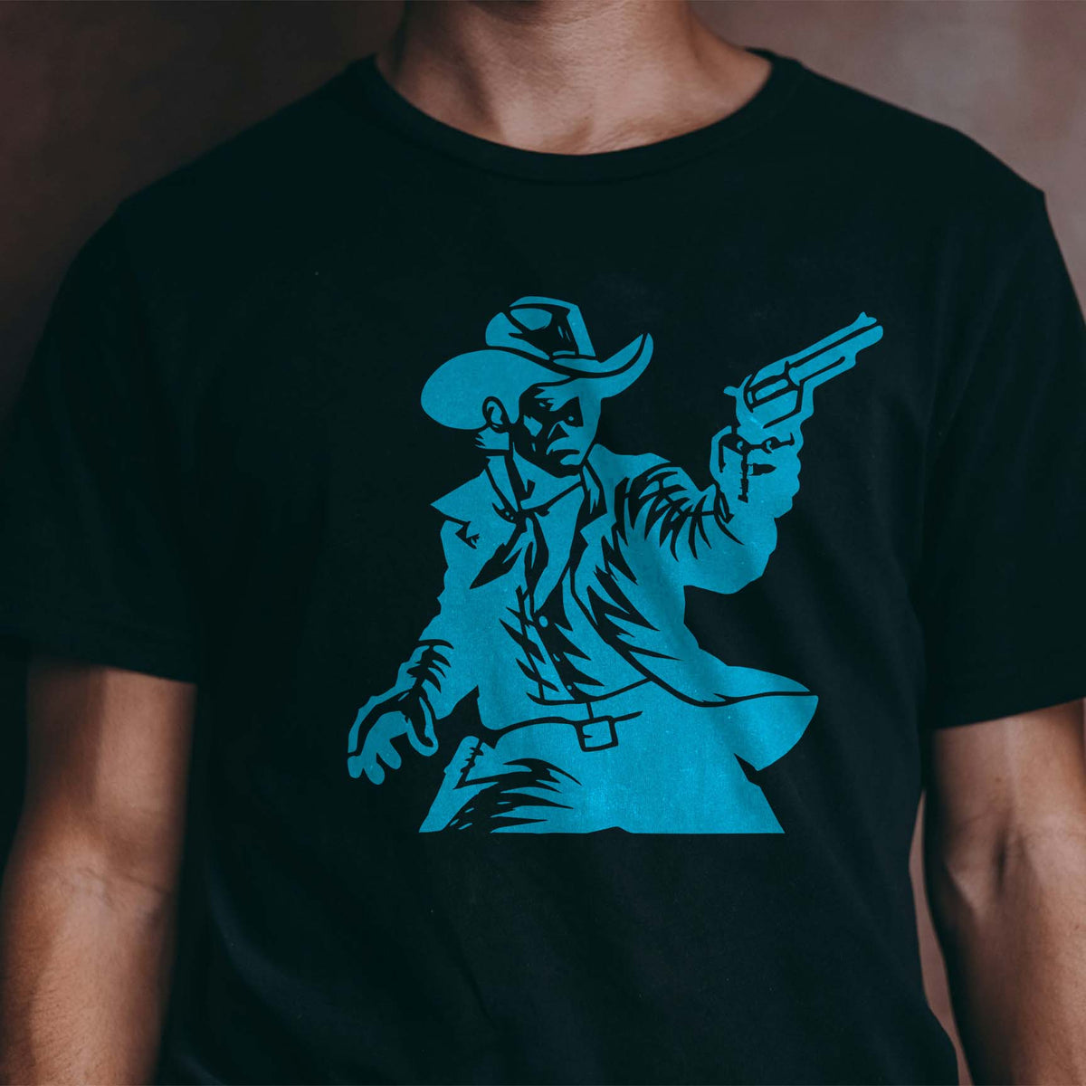 A blue Western Cowboy Revolver Stencil depicts a rugged gunslinger aiming his pistol on a black T-shirt.
