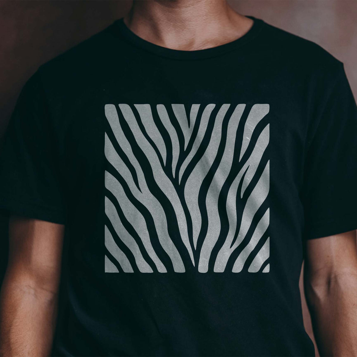 Wild Tiger Stripes Stencil brings flowing silver animal stripes to a black T-shirt