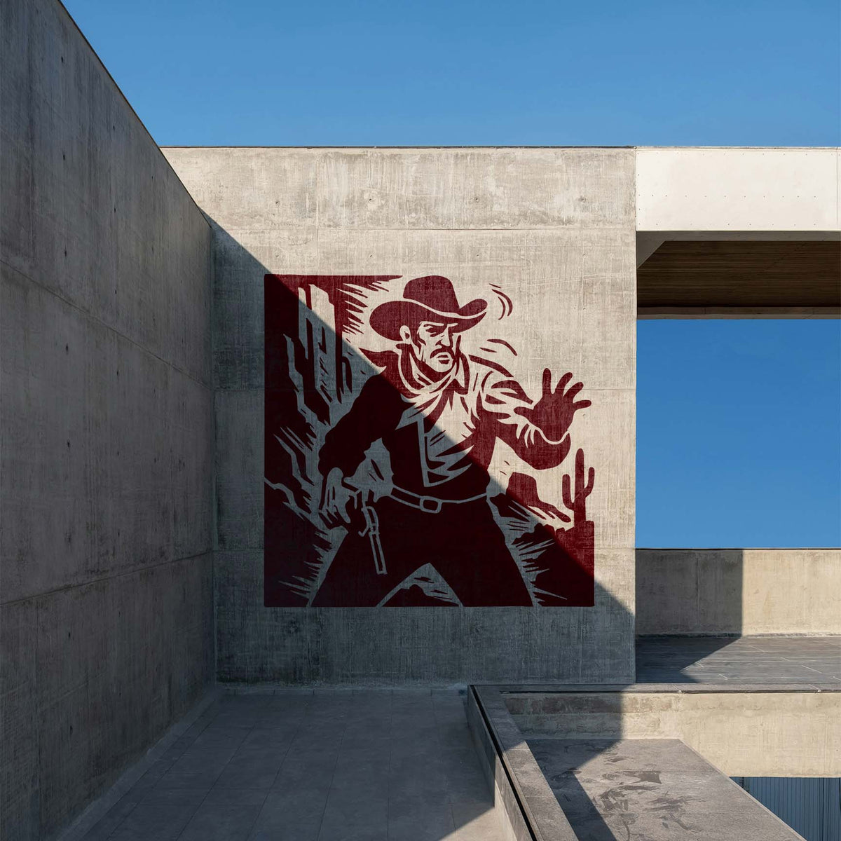 Wild West Cowboy Stencil painted large on a modern concrete wall under a blue sky