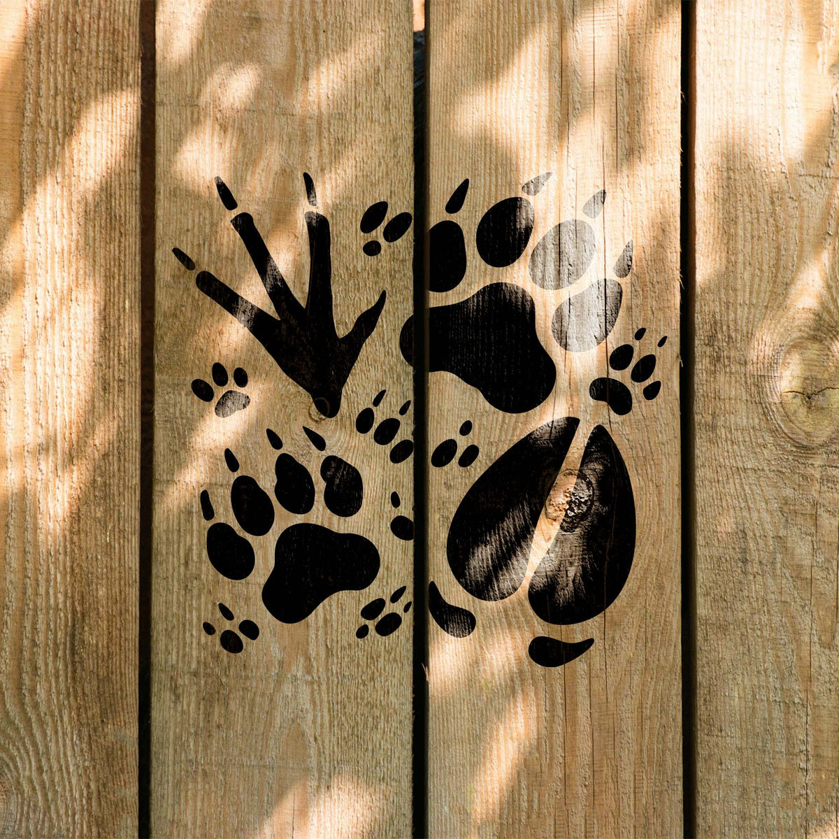 Rustic wildlife tracks stencil with mixed animal footprints on wood