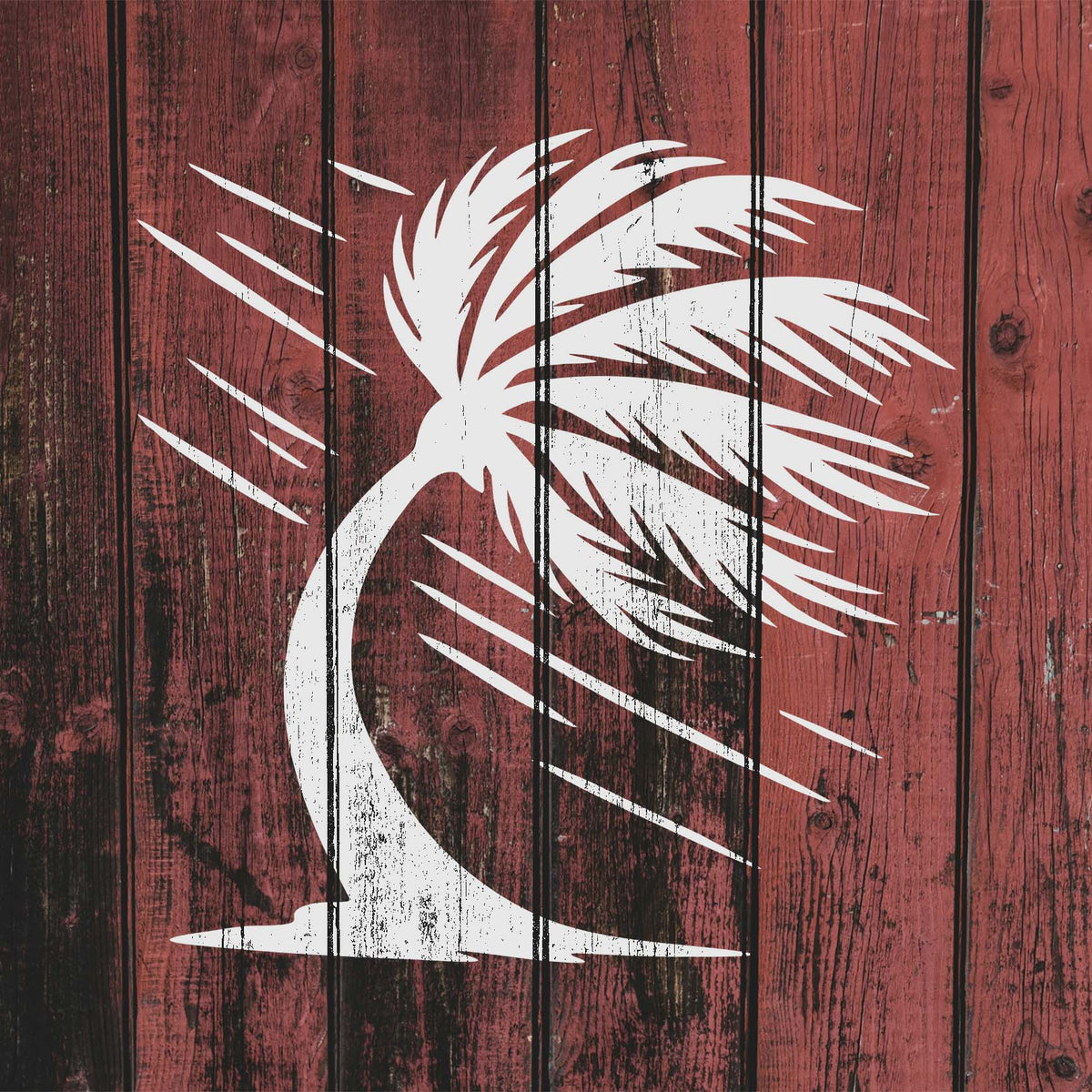 White windblown palm tree stencil with sweeping fronds on rustic wood
