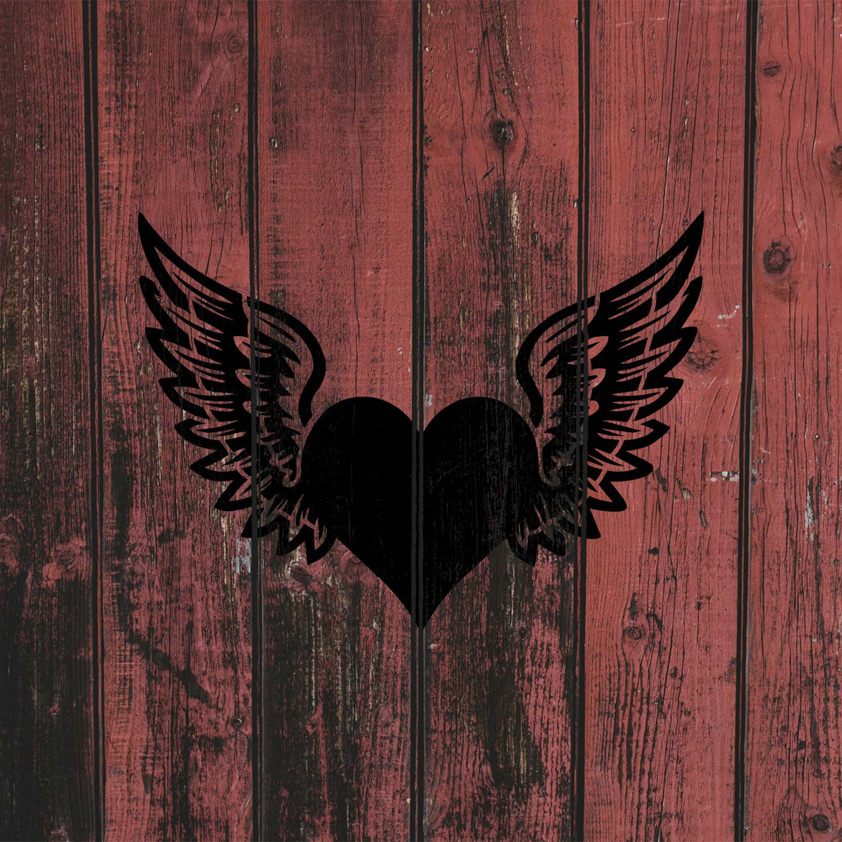 Rustic red wood displays the Winged Heart Love Symbol Stencil as a striking heart with spread wings