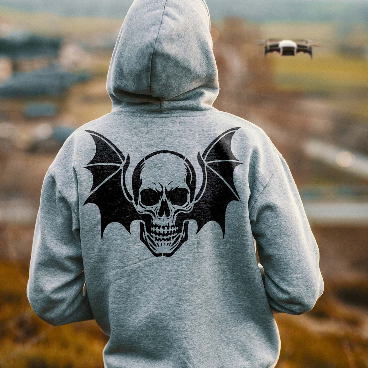 Winged Skull Gothic Stencil spreads bold bat wings across the back of a gray hoodie