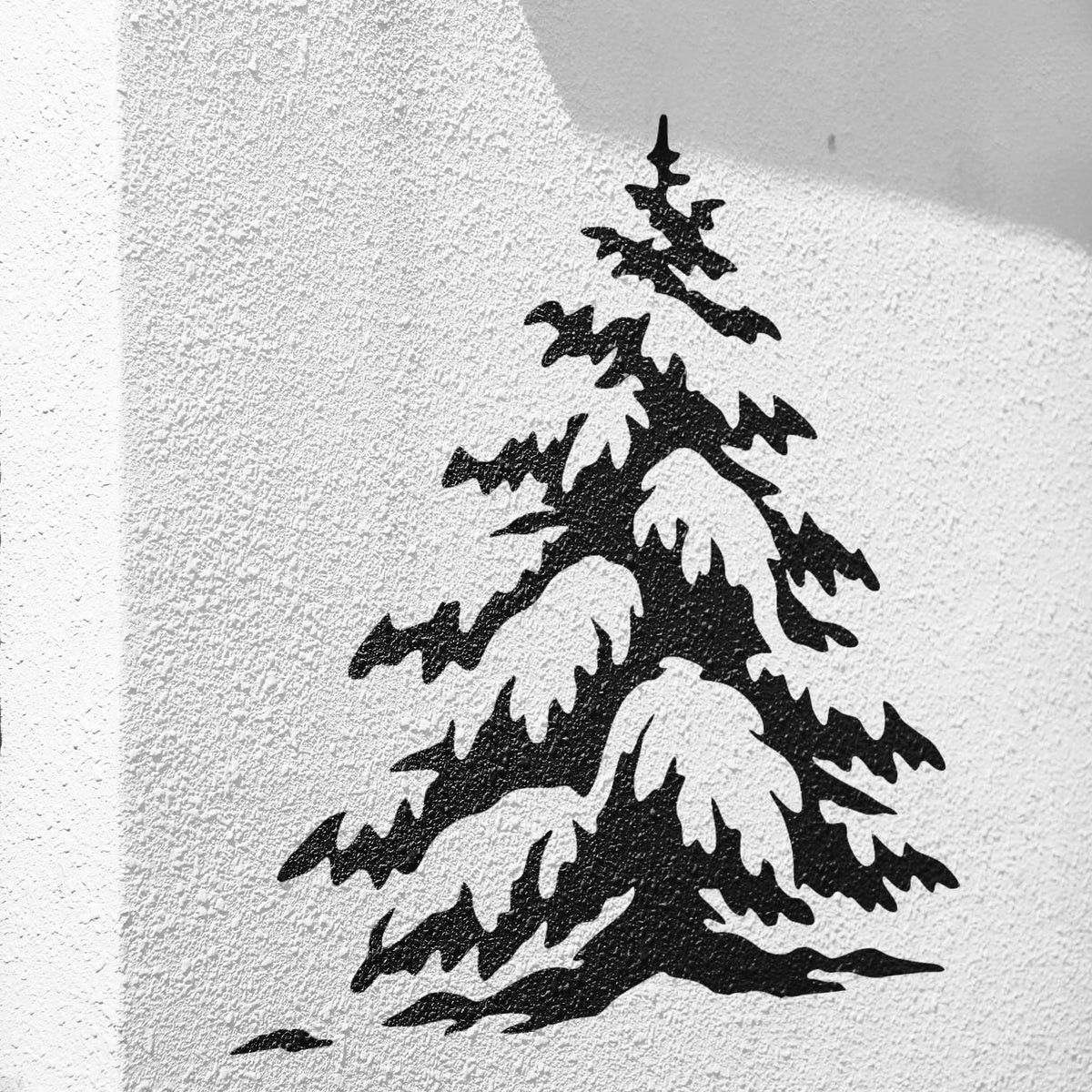 Winter evergreen pine stencil with snow-covered branches on a textured white wall