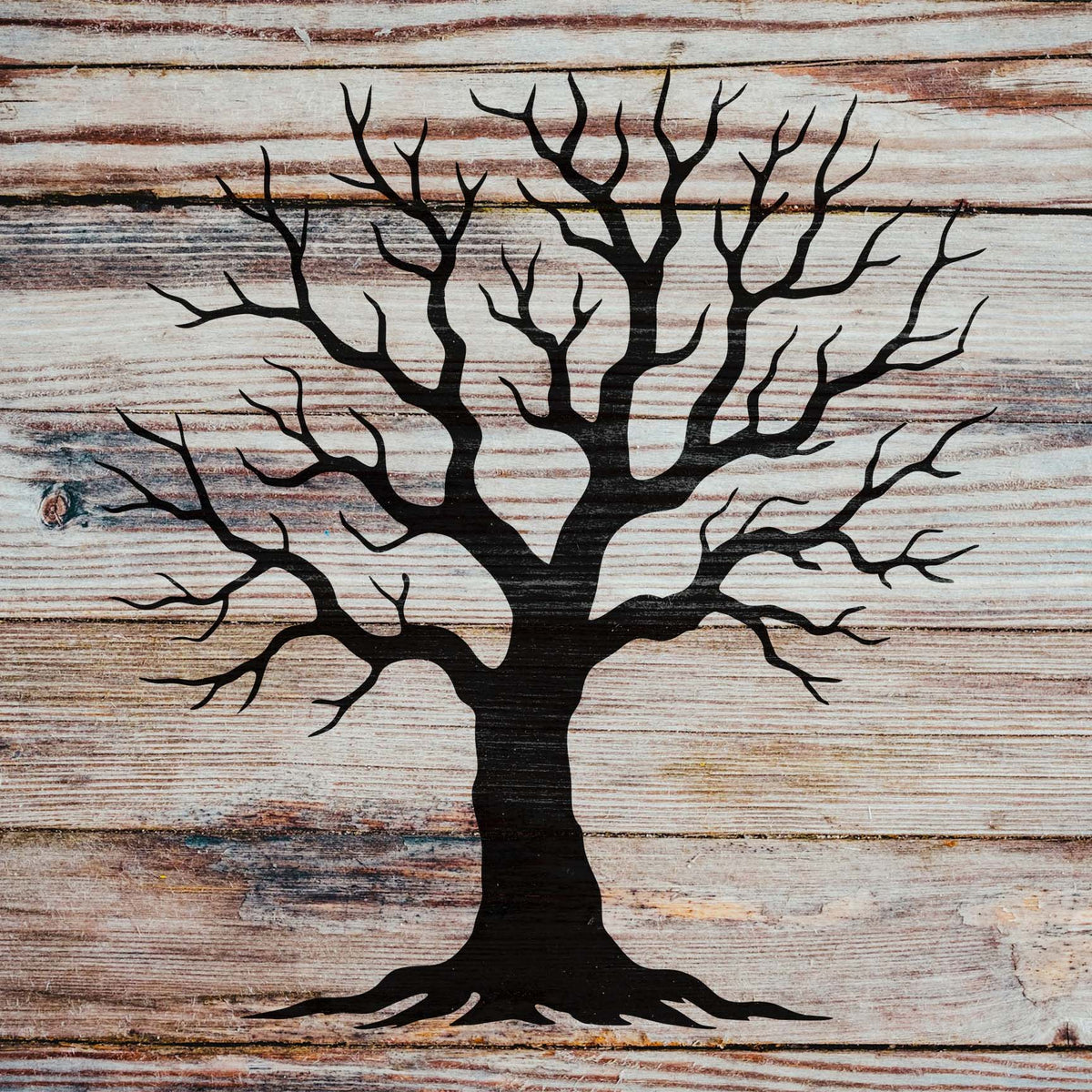 Winter tree stencil with detailed bare branches painted on rustic wood
