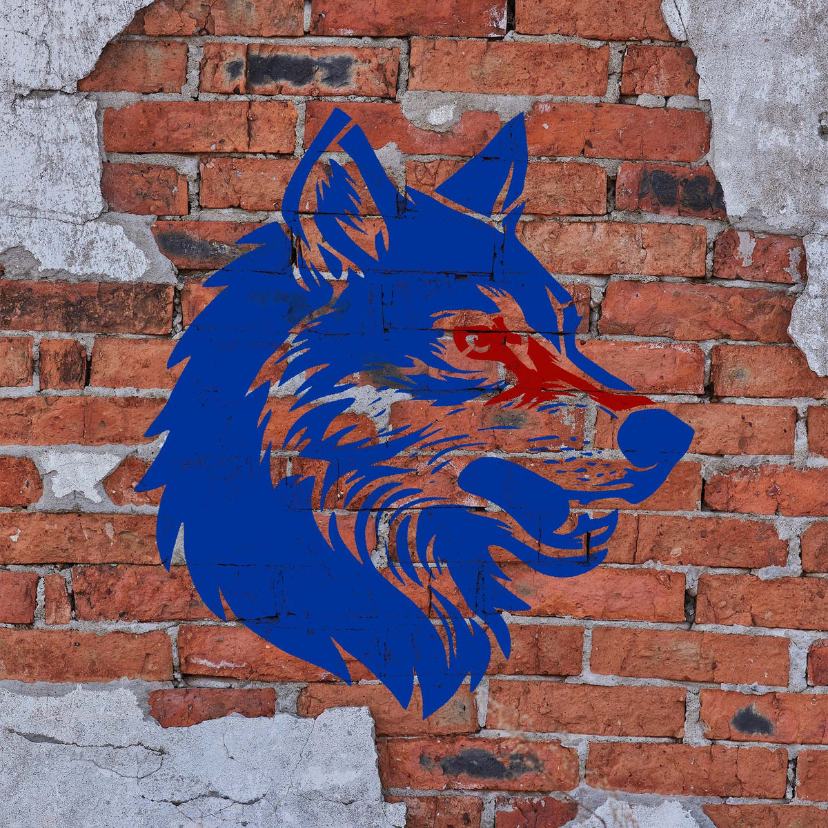 Wolf Head Profile Stencil painted in blue and red on a weathered brick wall