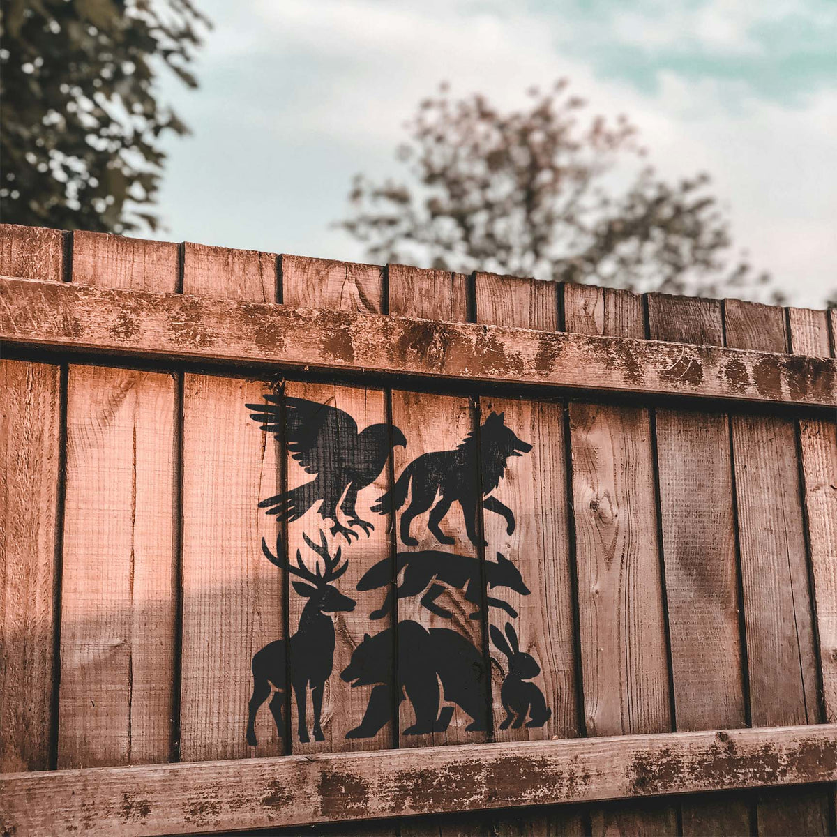Woodland Animal Silhouette Stencil features eagle, wolf, fox, deer, bear and rabbit on a fence