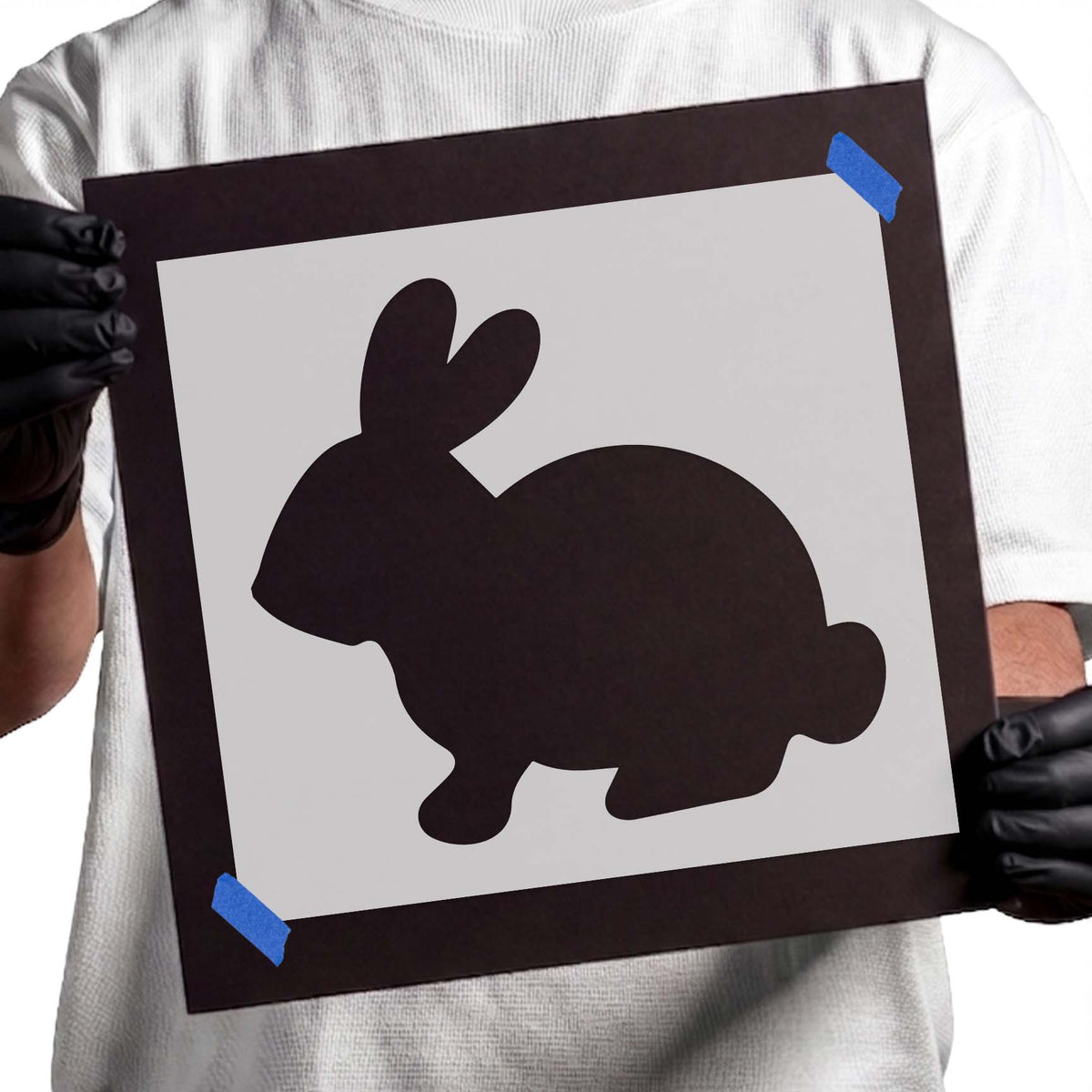 Side profile bunny silhouette with upright ears and rounded tail