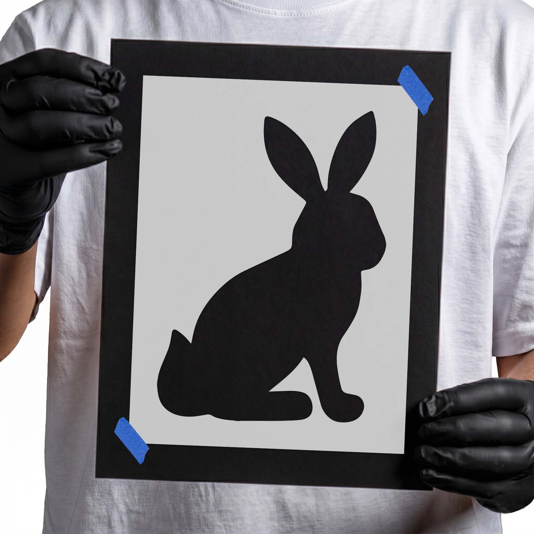 Seated rabbit silhouette with long upright ears in side profile
