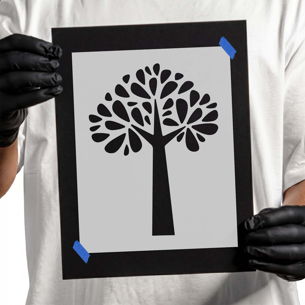 Stylized tree stencil with branching canopy and teardrop-shaped leaves