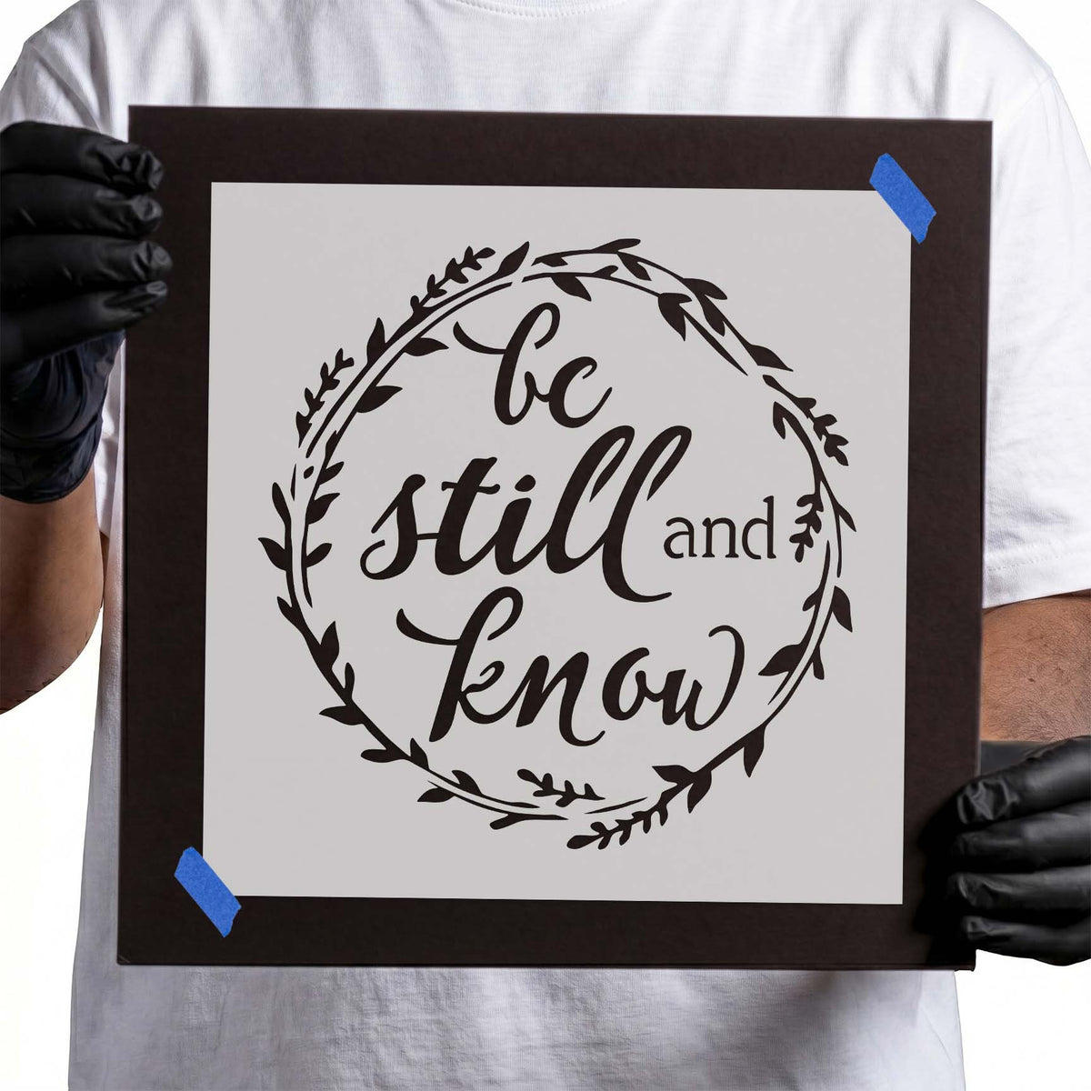 Be still and know lettering stencil surrounded by leafy wreath