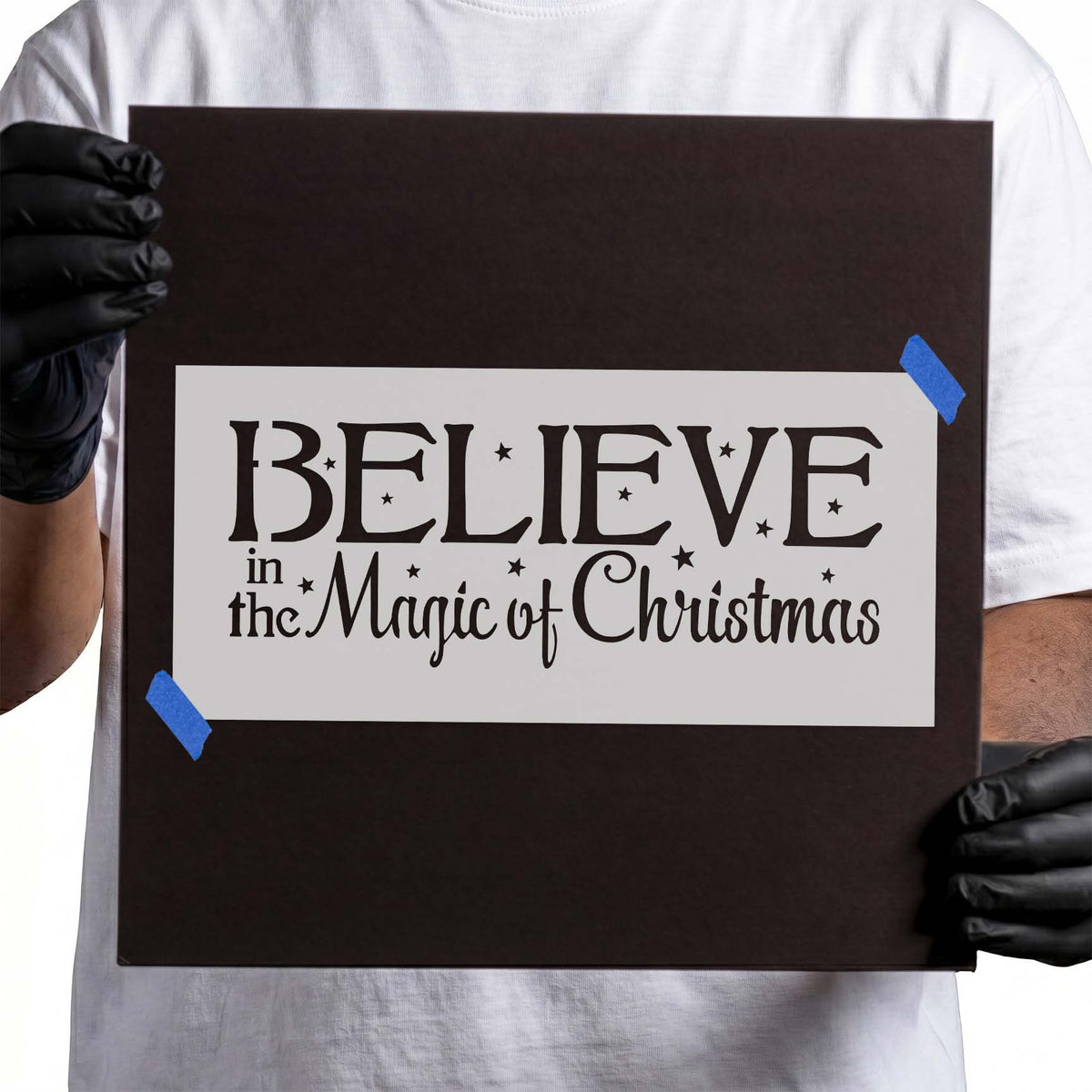 Christmas stencil with Believe lettering, festive script, and scattered stars