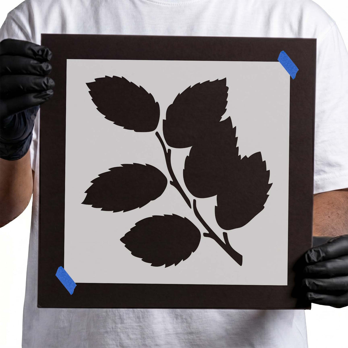 Leafy branch stencil with seven serrated leaves and branching stem