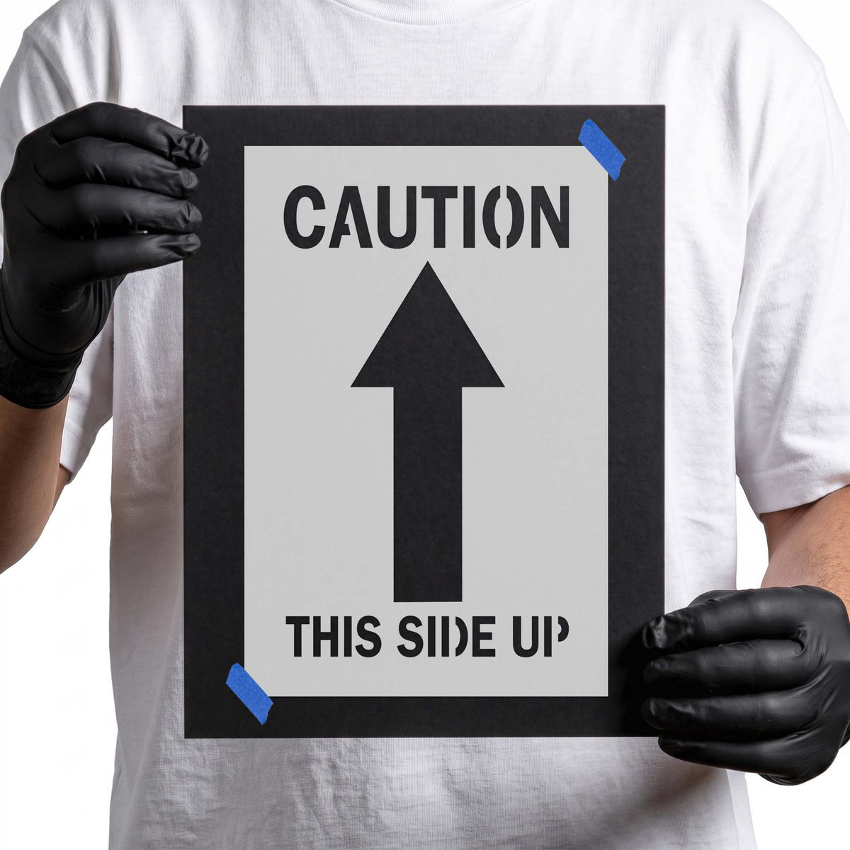 Caution stencil with large upward arrow and this side up lettering