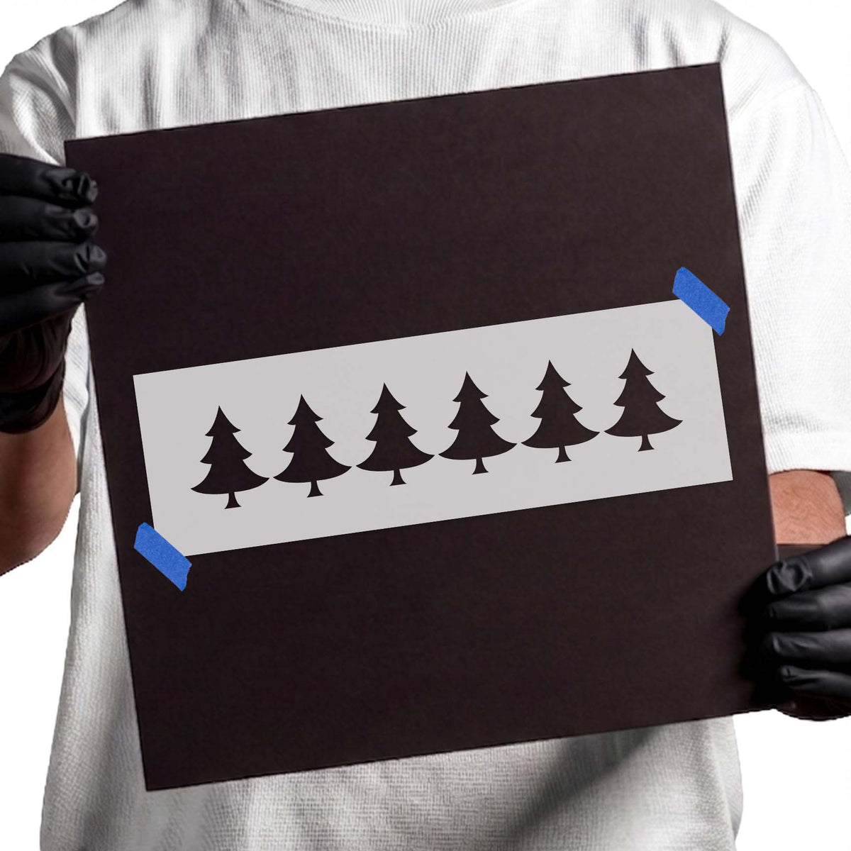 Stencil pattern with six evergreen Christmas tree silhouettes