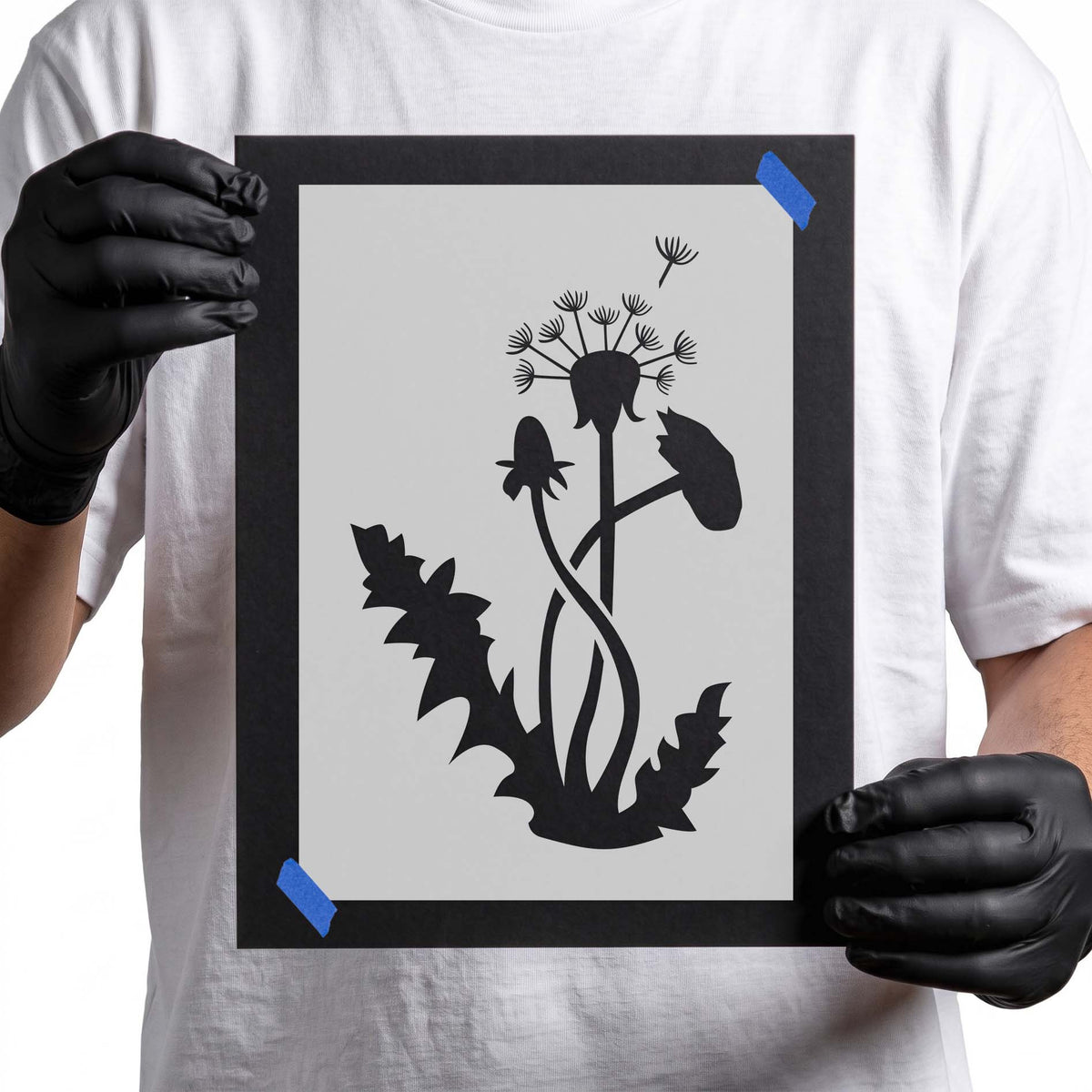 Dandelion stencil with leafy stems, flower heads, and drifting seed