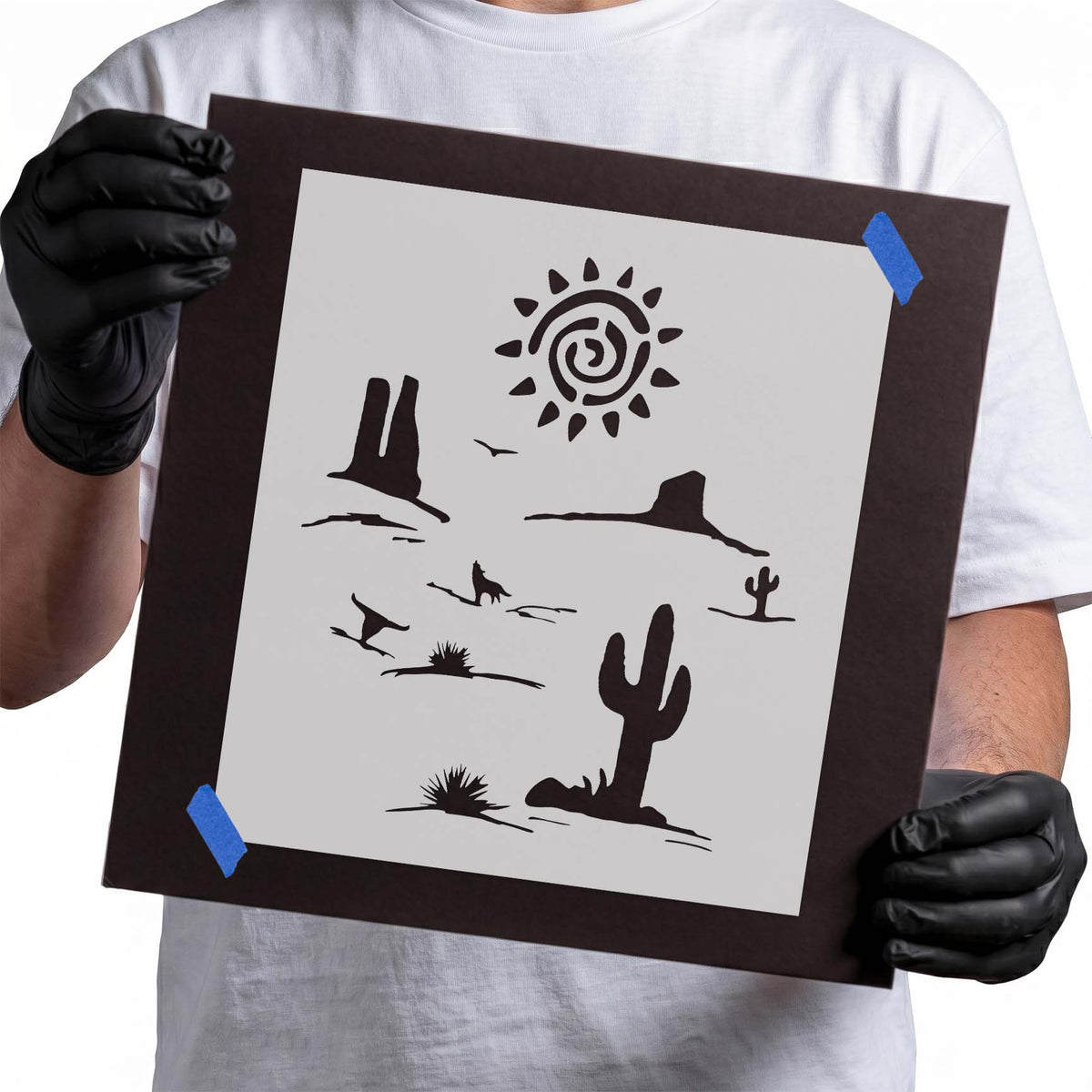 Desert stencil with cacti, rock formations, and spiral sun