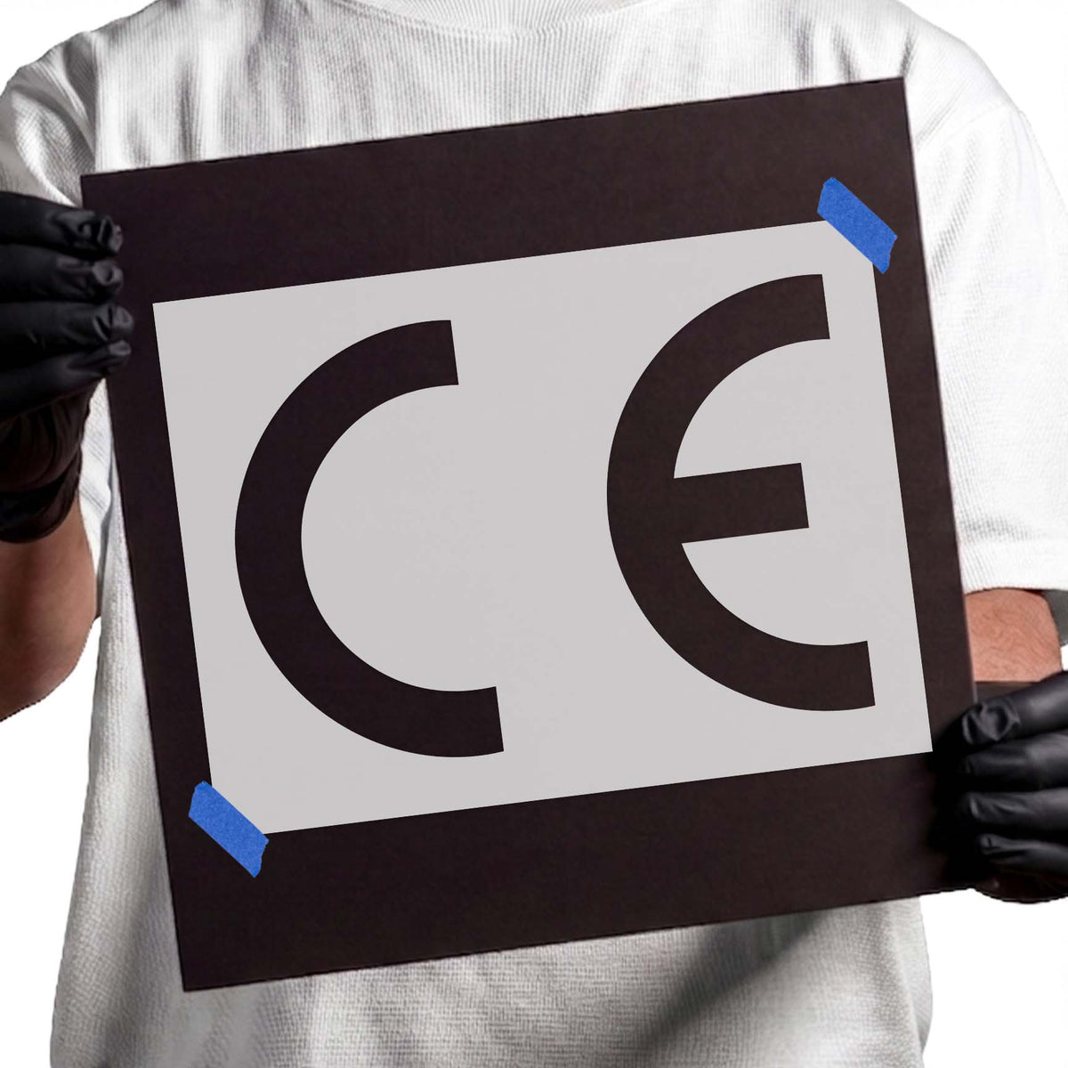 European Confomity CE Symbol Stencil showing bold curved CE letters on a white sheet and black board