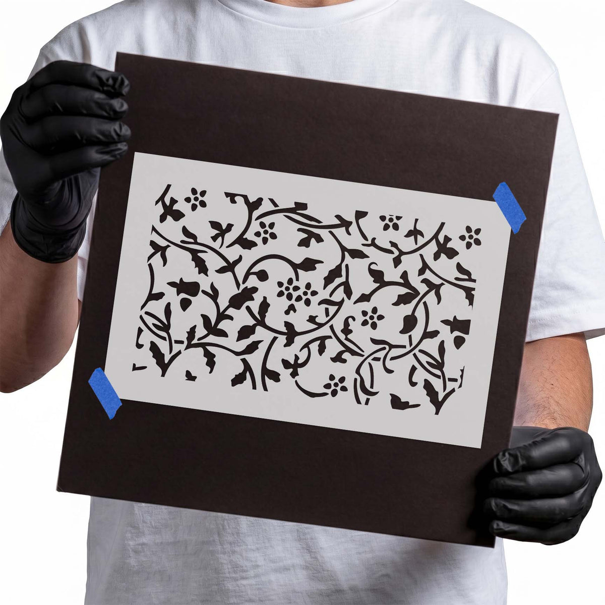 Floral vine stencil with curling stems, leaves, and small blossoms