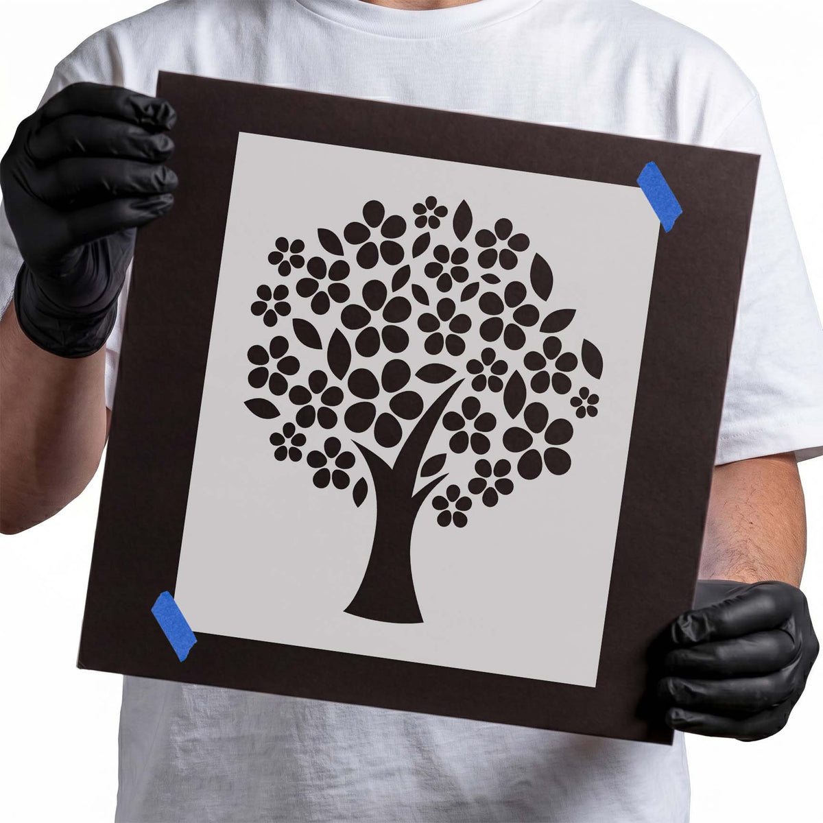 Flowery tree stencil with clustered blossoms and scattered leaves