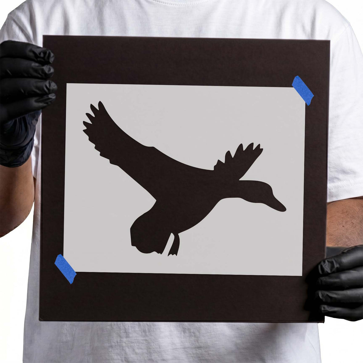 Flying duck stencil with spread wings and trailing feet