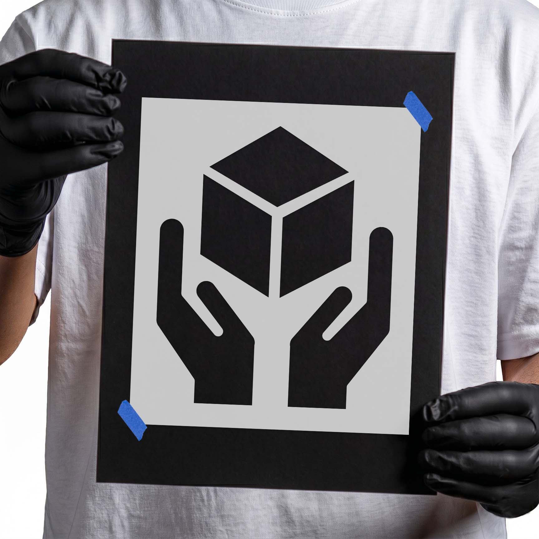 Handle with care stencil showing a box above two supporting hands