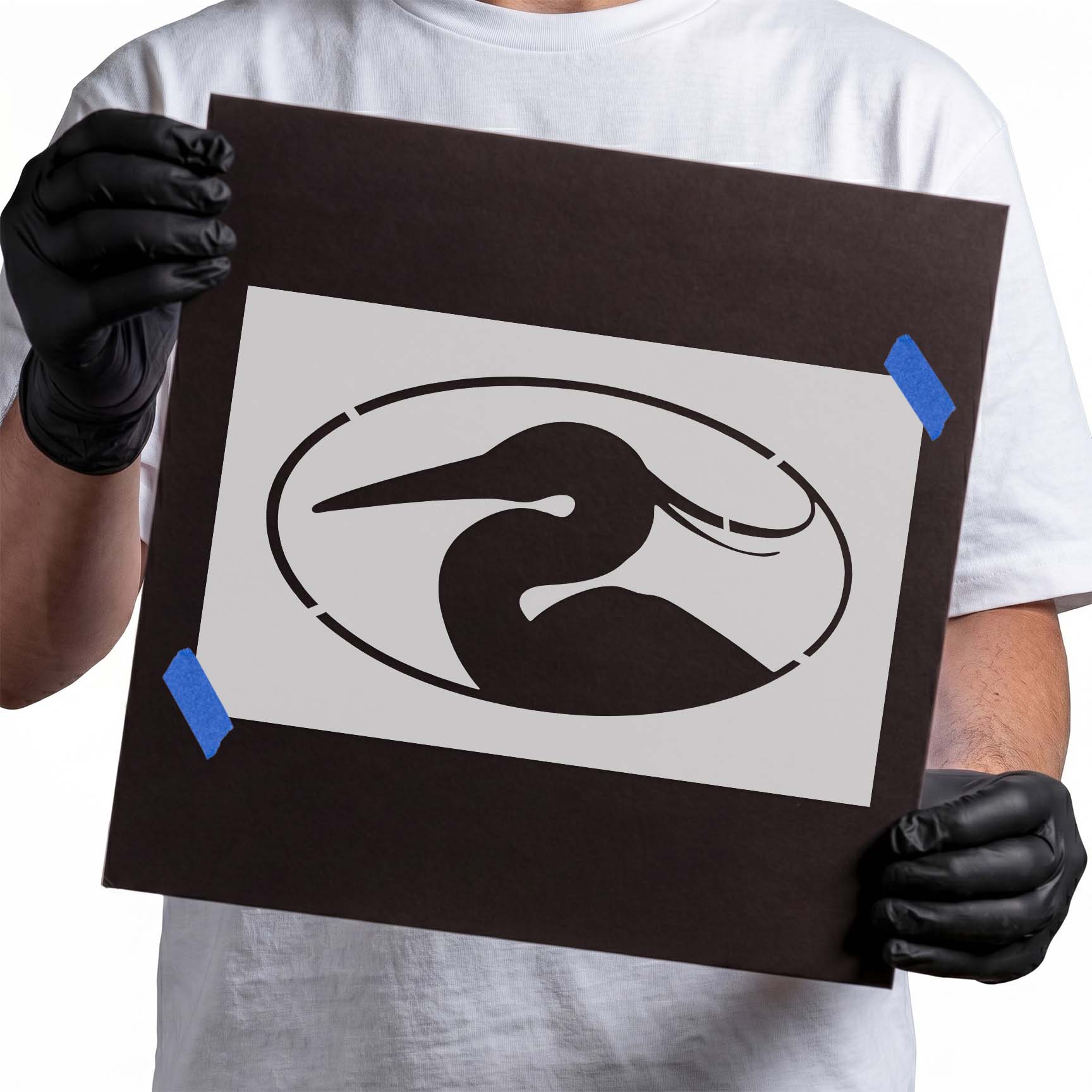 Person holding a laser-cut Heron Bird Stencil