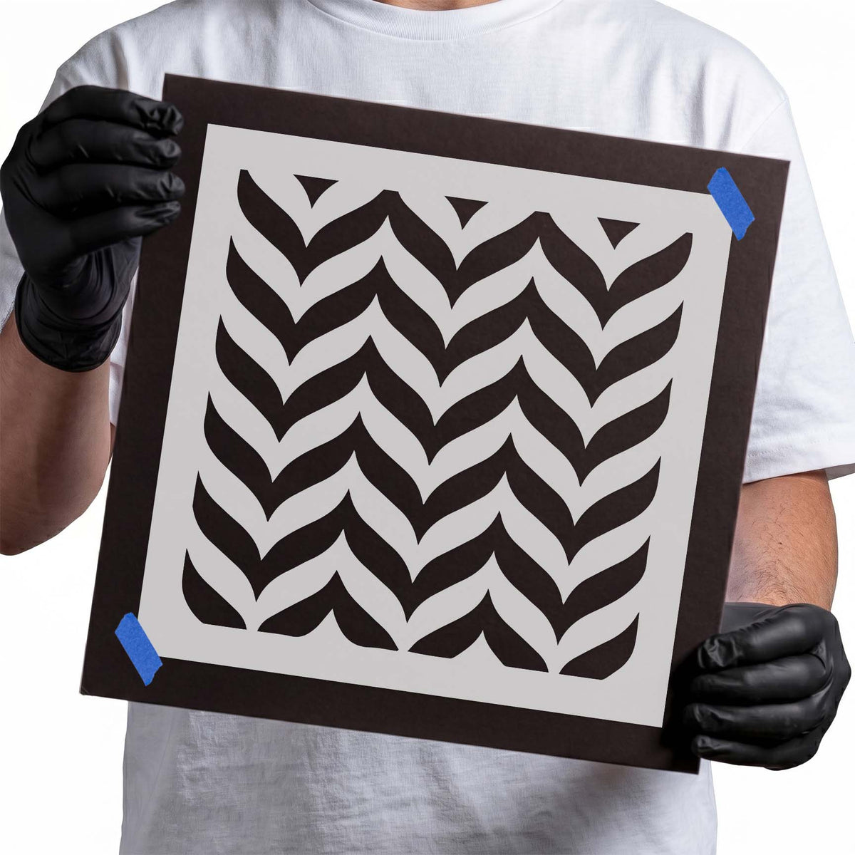 Herringbone stencil with repeating interlocking angled geometric pattern