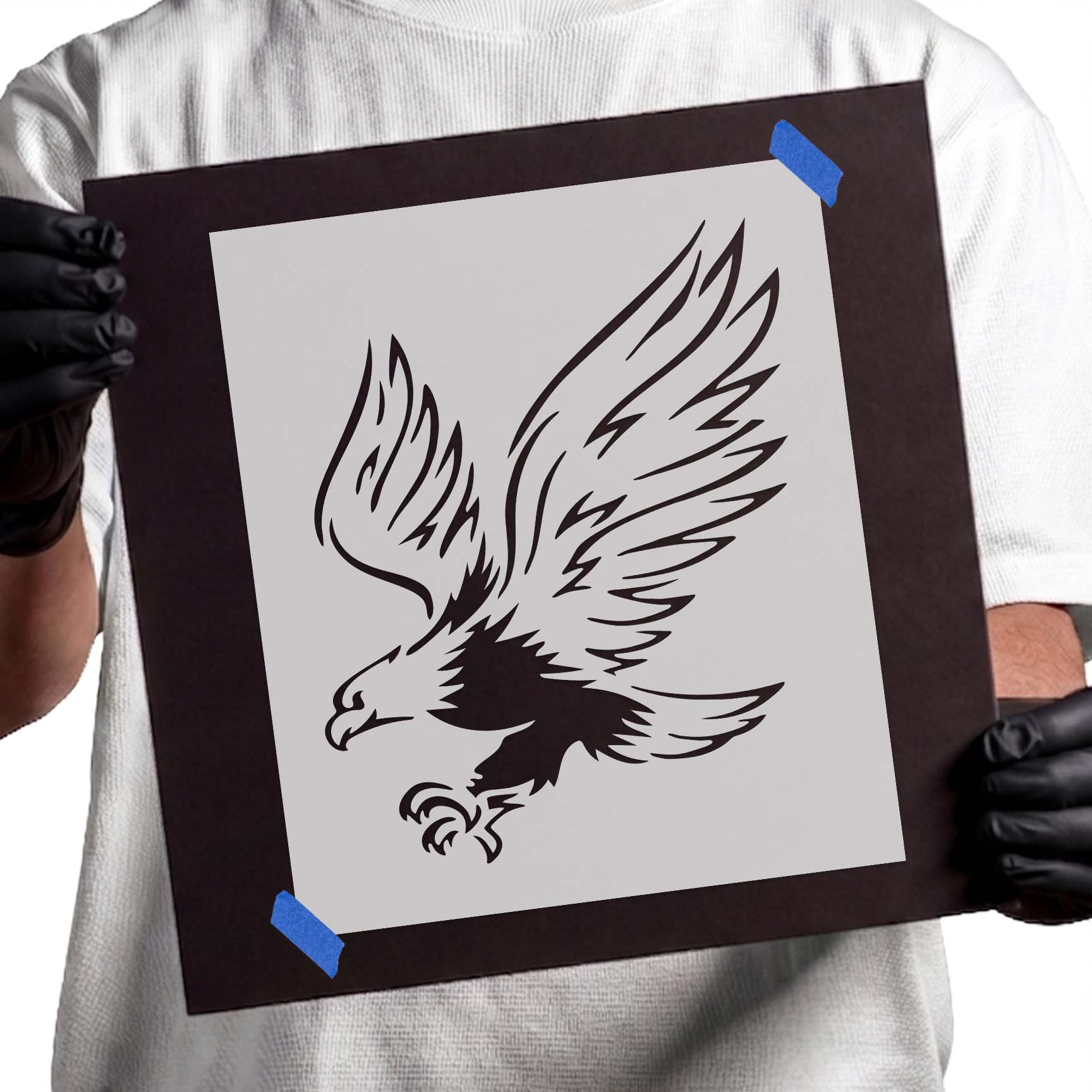 Landing eagle stencil with spread wings, feather details, and extended talons