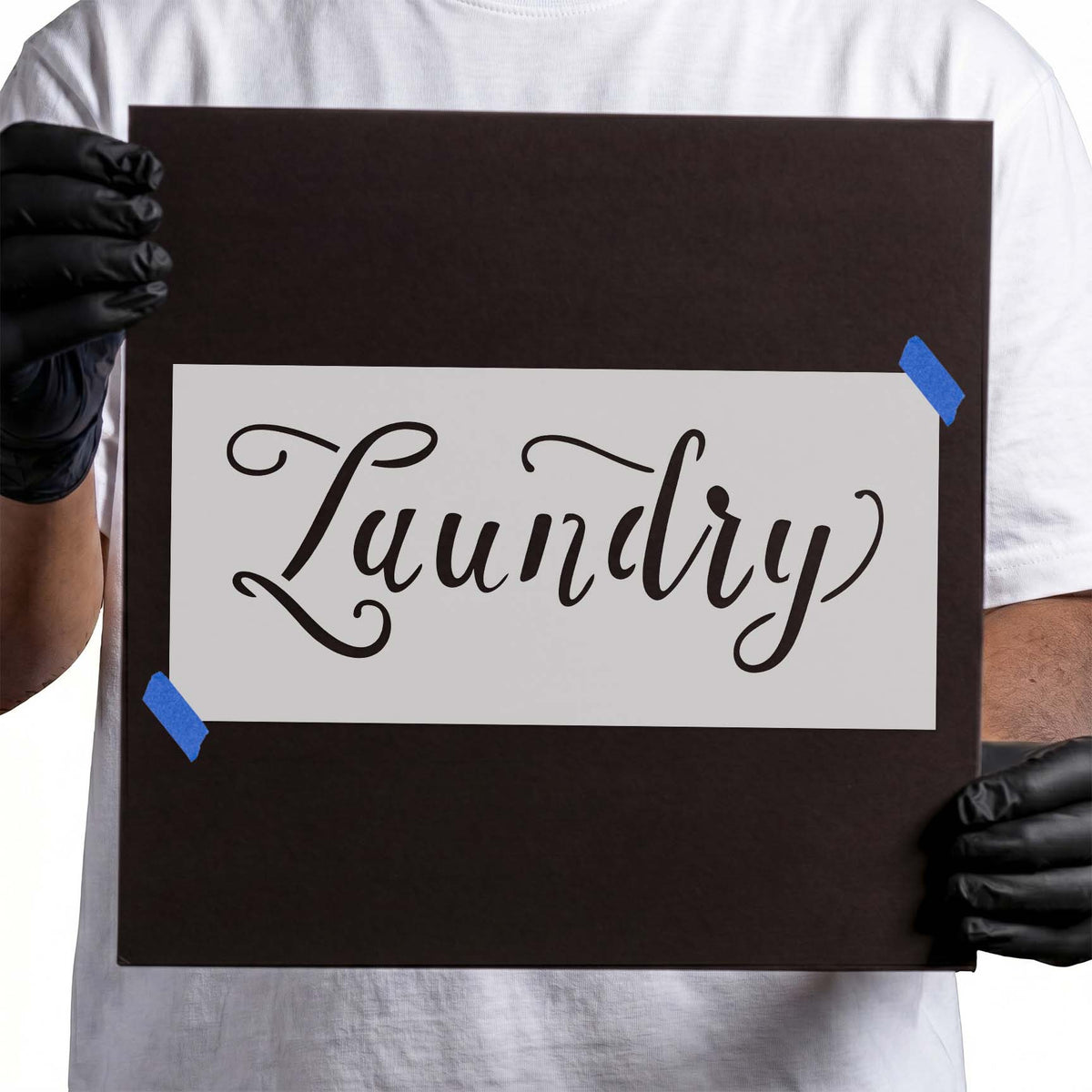 Laundry stencil with flowing script lettering and decorative flourishes