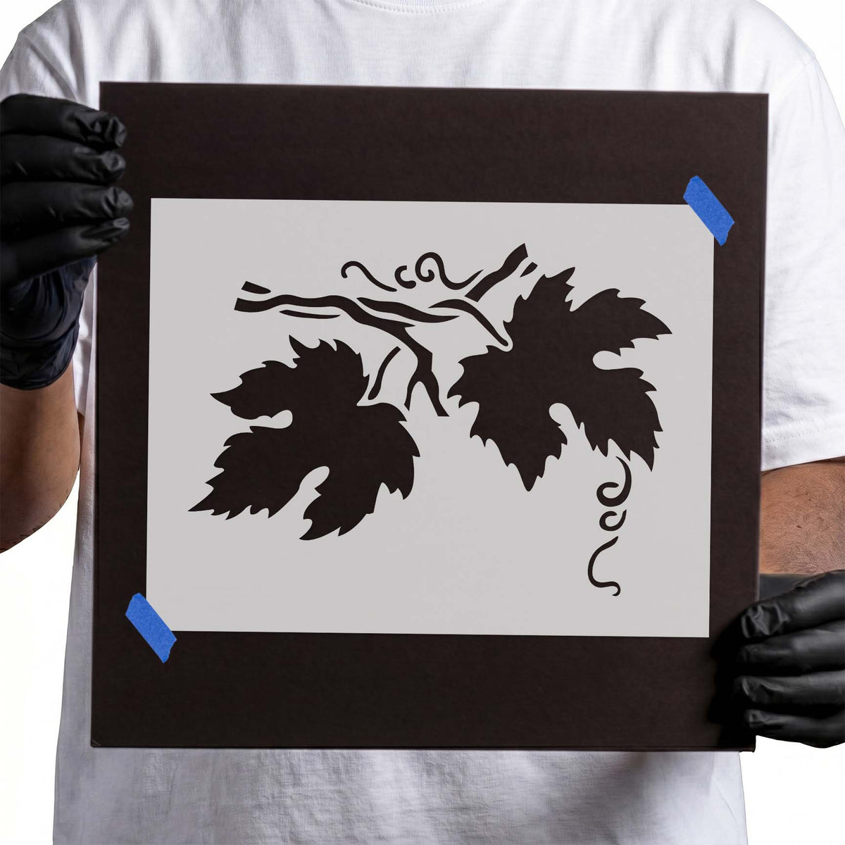 Leaf branch stencil with serrated foliage and curling tendrils