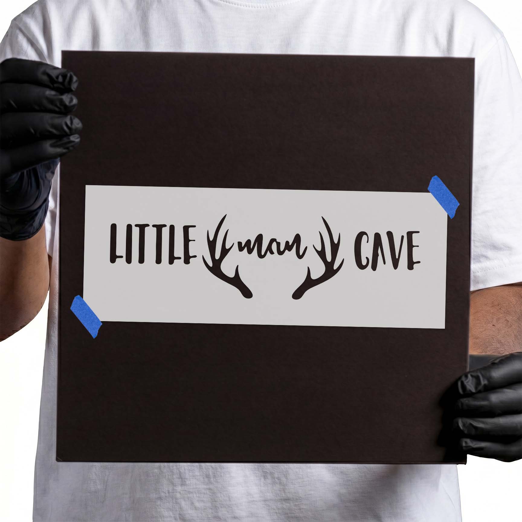 Little man cave stencil lettering framed by branching deer antlers