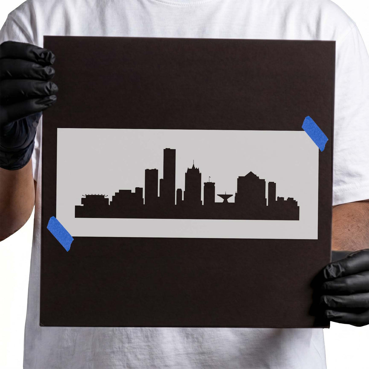 Person holding a reusable Milwaukee Skyline Stencil