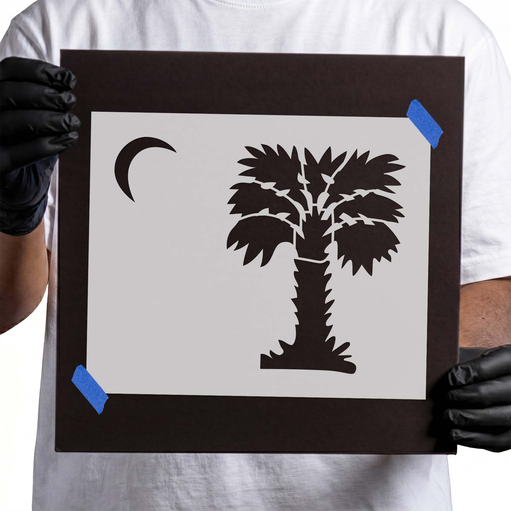 Person holding reusable Palmetto Tree and Moon Stencil