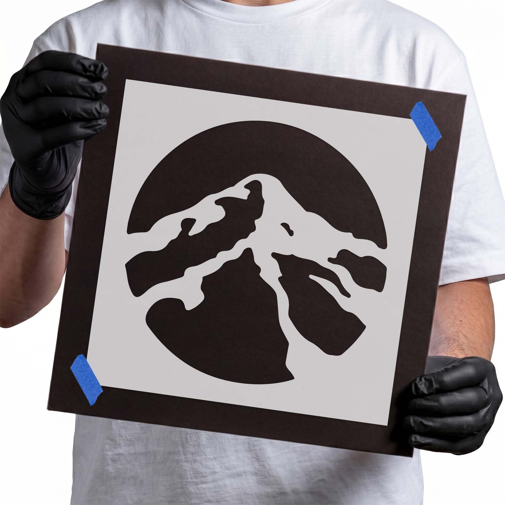 Mountain peak silhouette stencil inside a circular landscape design