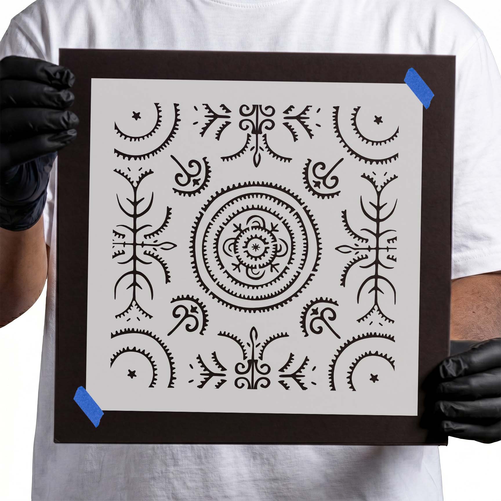 Ornate circular stencil with symmetrical flourishes, stars, and curved details