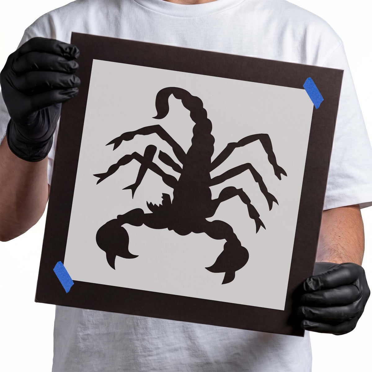 Scorpion stencil with raised pincers, eight legs, and curled segmented tail