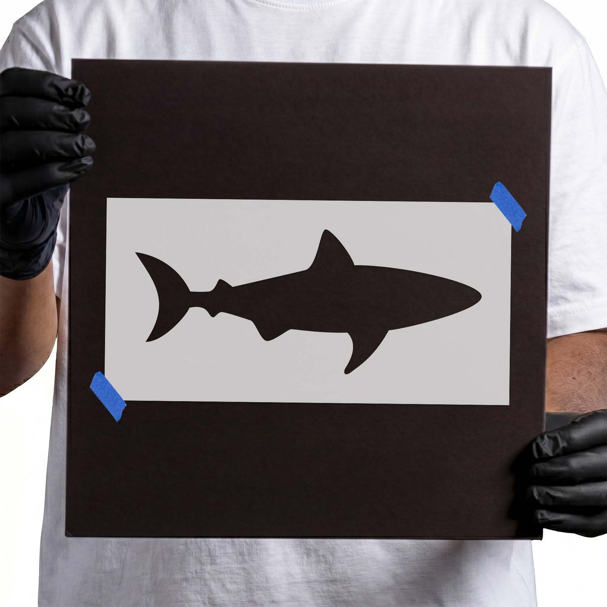 Shark stencil with dorsal fin, pointed snout and curved tail