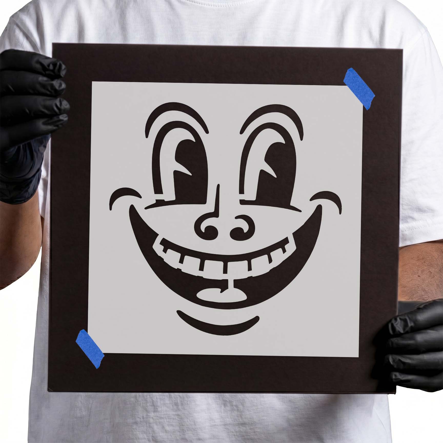 Person holding reusable Smily Face Stencil
