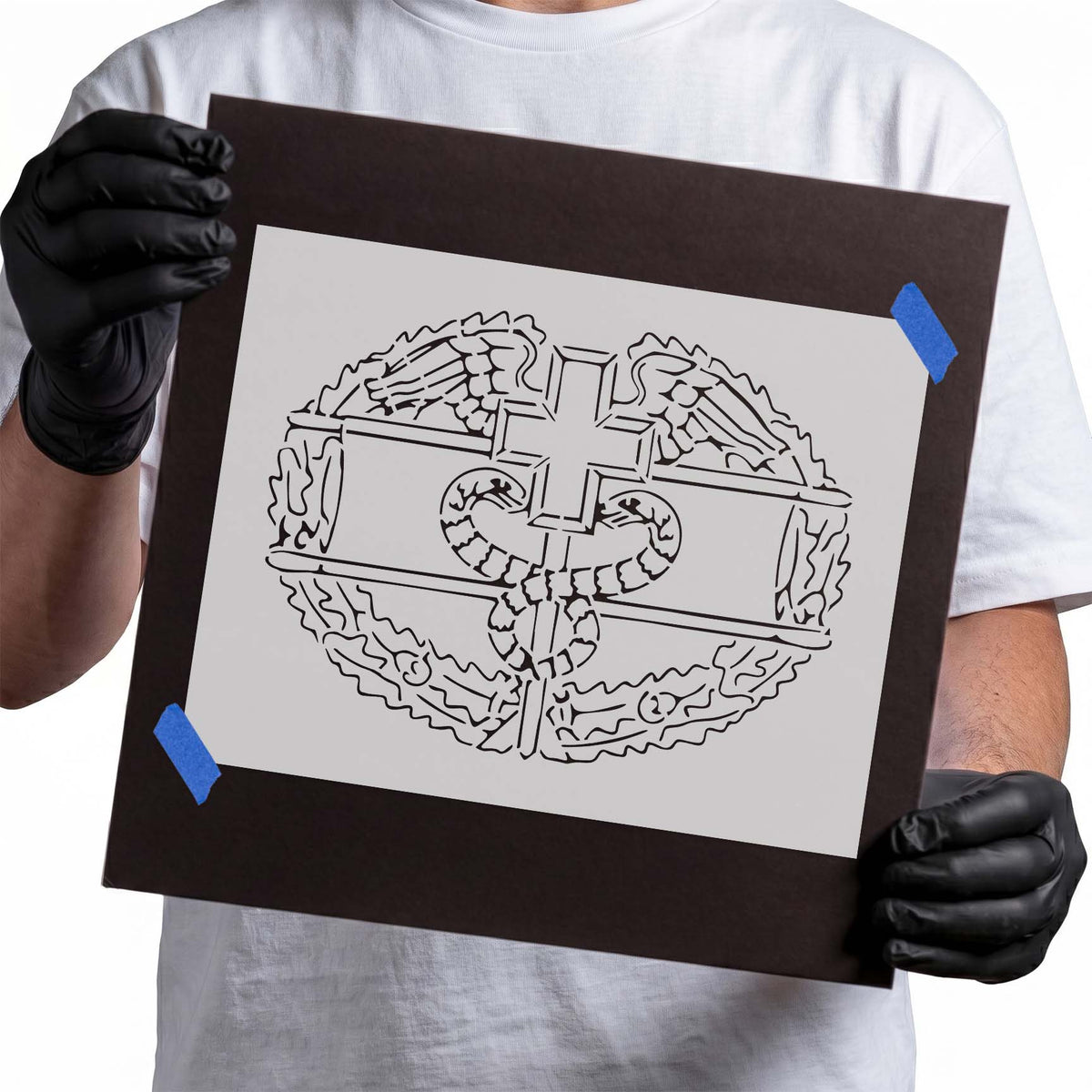 Snakes and cross stencil with coiled serpents, spread wings, and ornate details