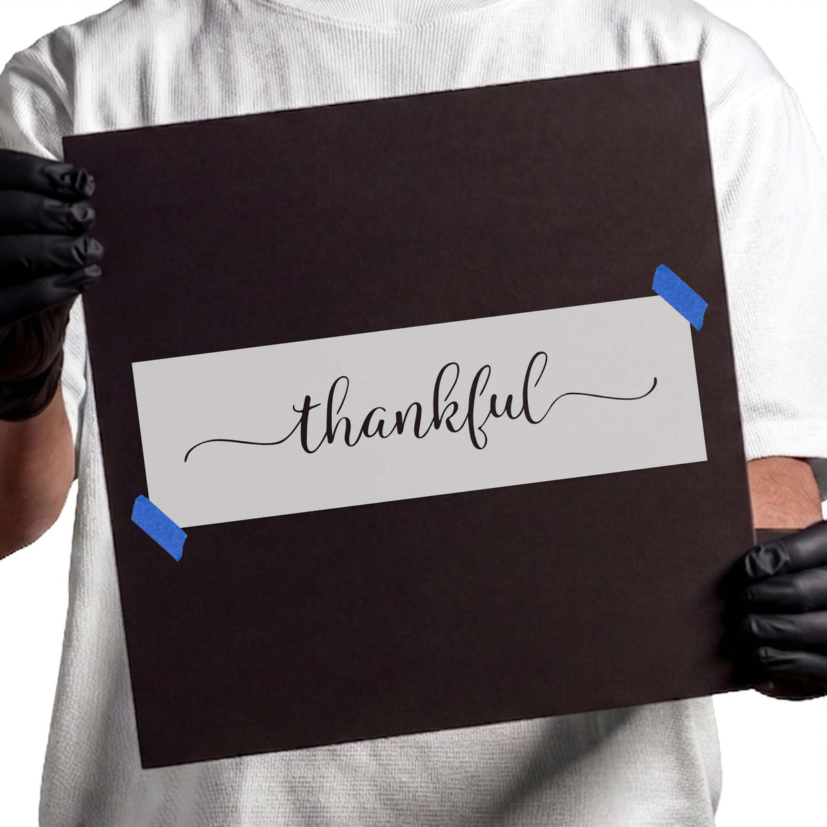Thankful stencil with flowing cursive lettering and decorative flourishes
