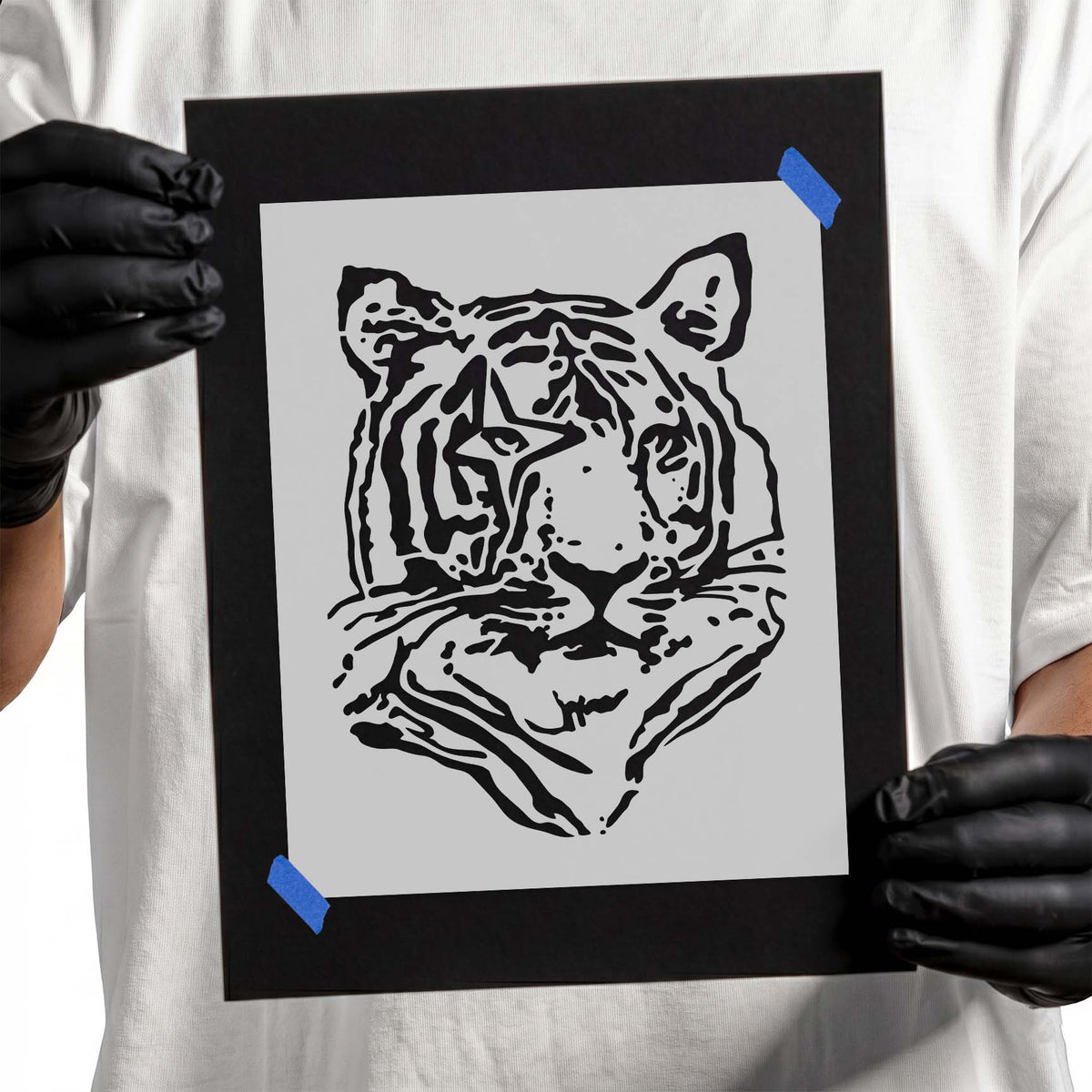 Detailed tiger head stencil with bold stripes and intense eyes
