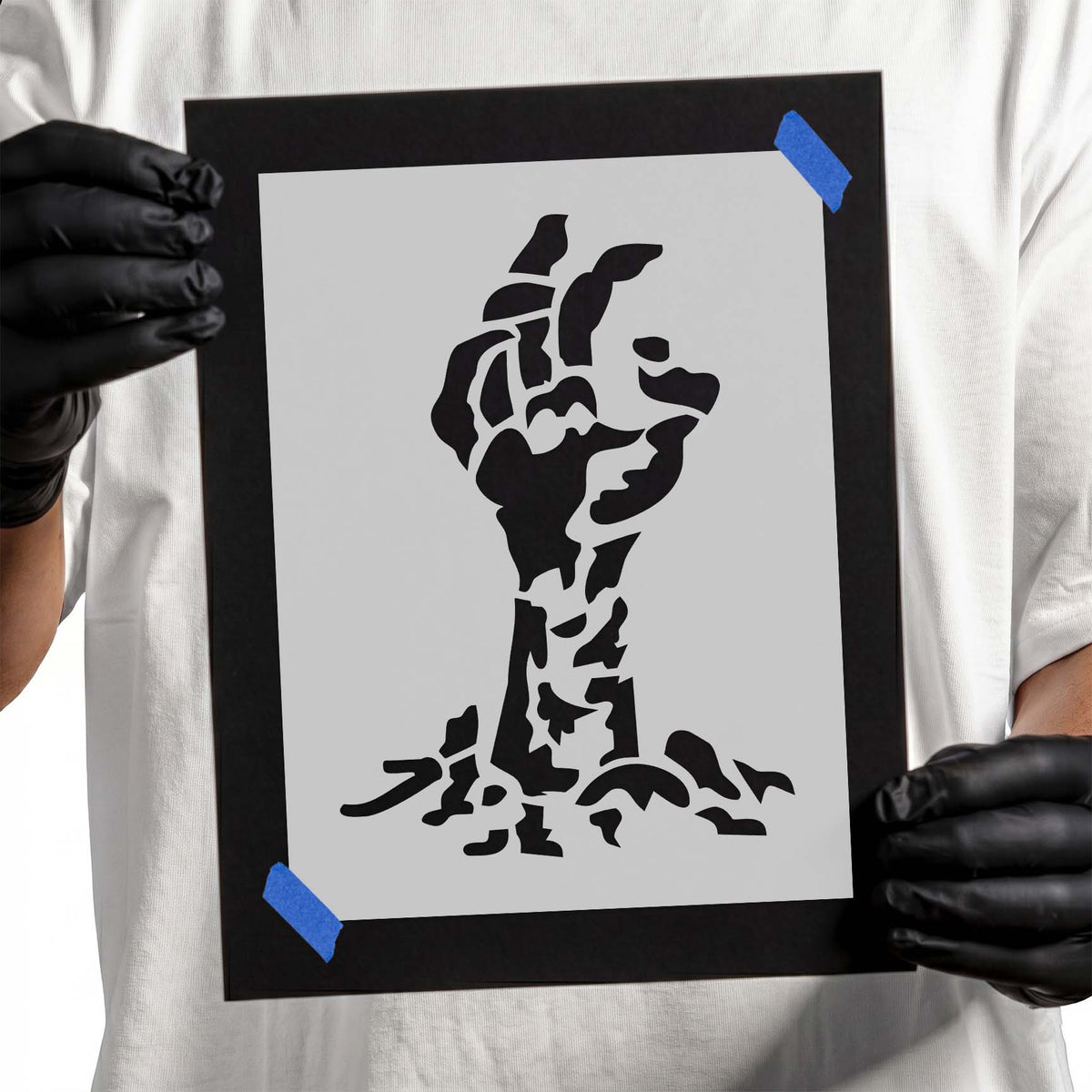 Rising zombie hand stencil with exposed bones and ragged ground details